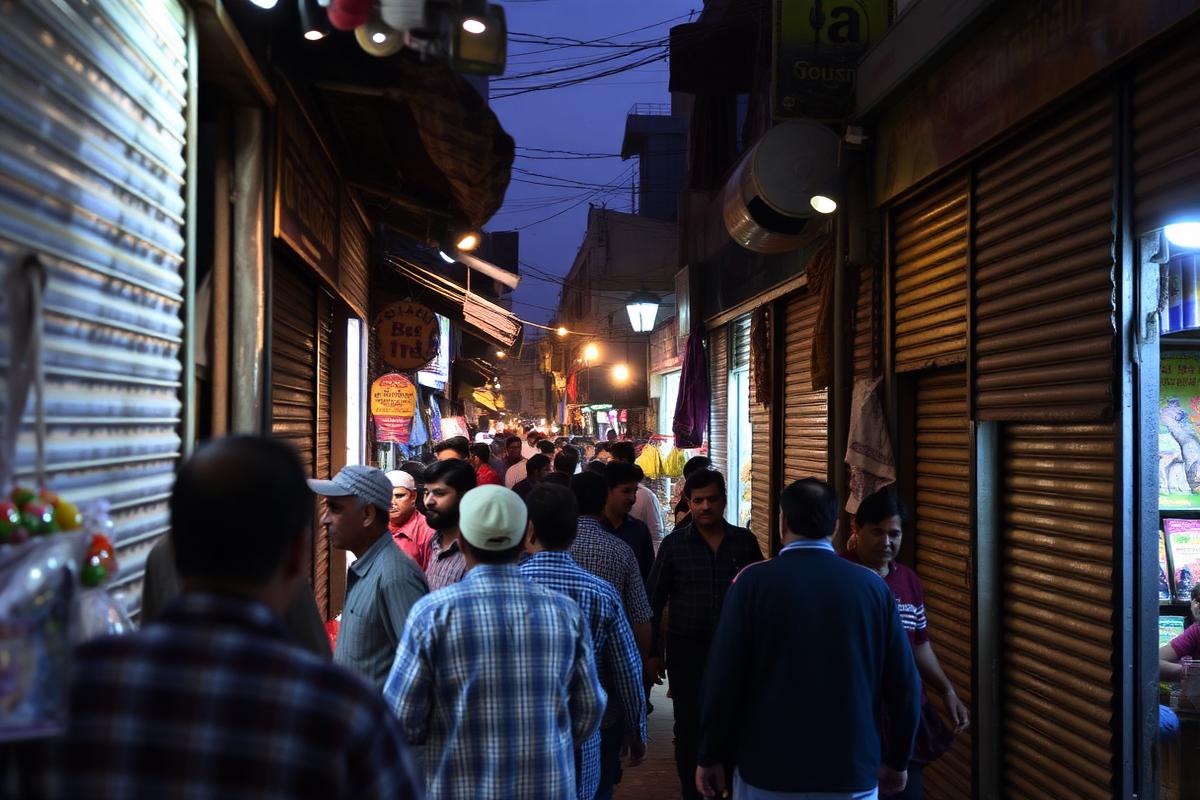 A shopkeeper at Aabpara Market prepares to close for the night under the capital's revised business-hour schedule.